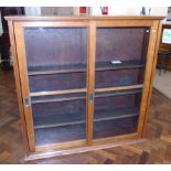 Mid 20th century light oak cabinet with two glazed sliding doors Condition reports not available for