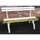 Victorian garden bench with wooden slats to seat and back and cast iron legs with supports in the