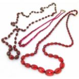 Three red bead necklaces, to include a red glass necklace, and red plastic bead necklaces (3).