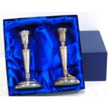 Two silver candlesticks, of slightly tapering form with circular spreading base, hallmarks for L J