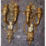 A pair of reproduction gilt metal effect double wall sconces decorated with Parian effect cherub