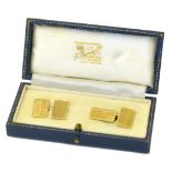 A pair of 9ct gold cufflinks, each designed as a pair of engine turned and polished rectangular