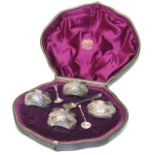 A Victorian silver cruet set, comprising four open salts with repoussé floral decoration, and