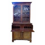 George III mahogany bookcase on secretaire base, top section with two astragal glazed doors (one