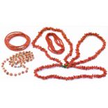 A selection of coral bead jewellery, to include a triple strand necklace, a bangle and two further
