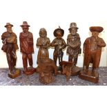 Six carved continental style figure, one being a tobacco jar, carved character style mug and