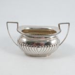 A silver two handled sugar bowl, with gadrooned edge and lower body, Sheffield 1914, weight 8oz