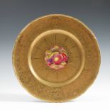 A Royal Worcester cabinet plate, the centre decorated with fruit to a mossy background by H Henry,
