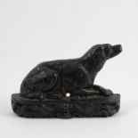 A 19th century black metal door stop, formed as a recumbent Spaniel dog, the base decorated with