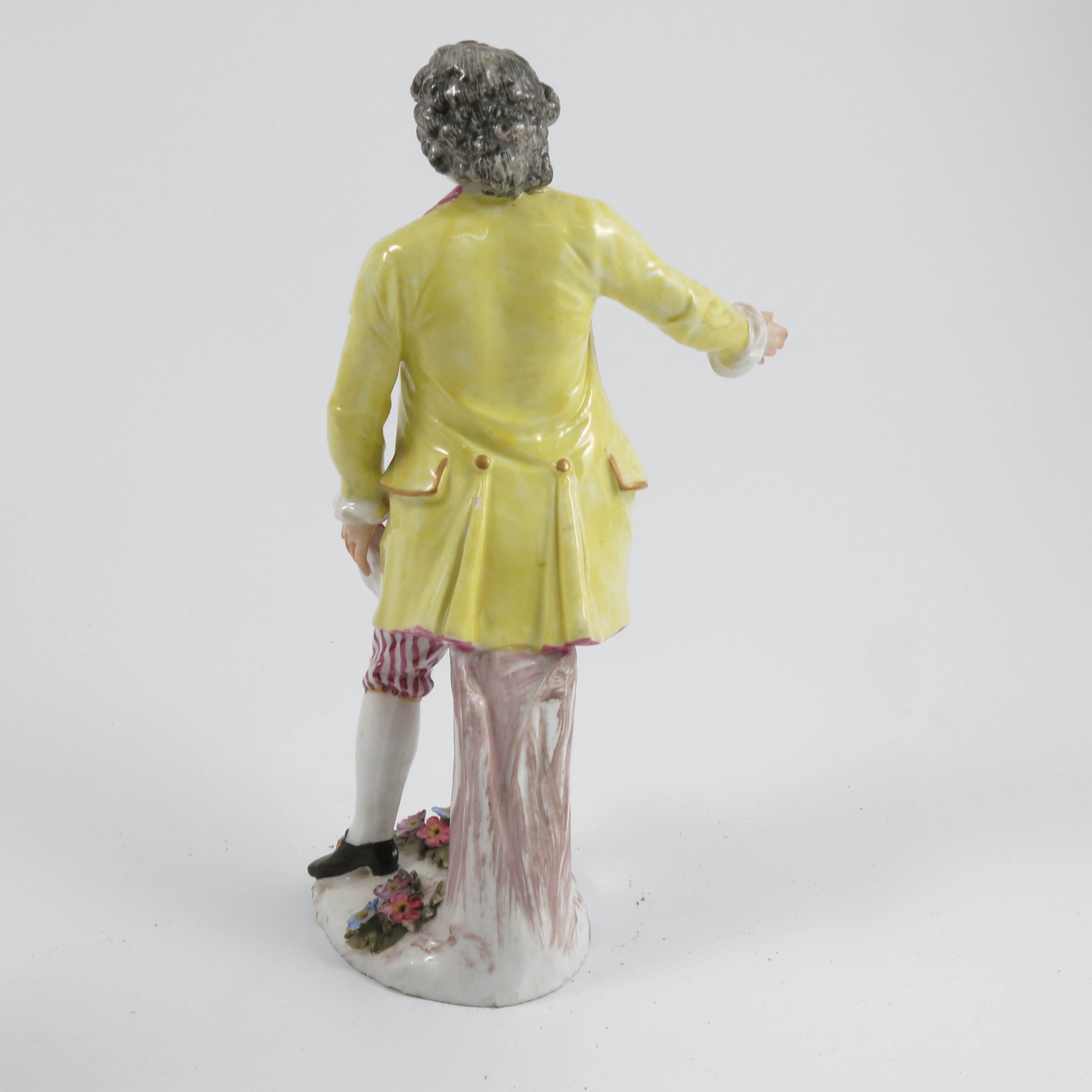A pair of late 19th century continental porcelain figures, of a man wearing a yellow jacket and a - Image 8 of 9