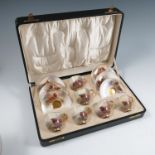 A cased Royal Worcester set of coffee cups and saucers, decorated with Highland cattle in