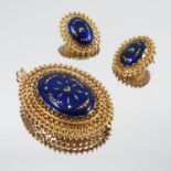 An enamel pendant brooch, stamped '9ct', the oval panel within a wire work frame, with matching