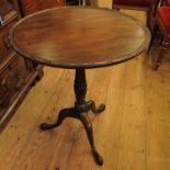 A 19th century mahogany tilt top tripod table, raised on a turned column terminating in three