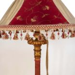 A gilt wood lamp standard, the column carved with leaves and bands of material, to a stepped