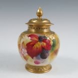 A covered Royal Worcester vase, with gilt pierced cover, the quarter lobed body decorated to the