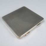 A silver cigarette case, of square form with engine turned decoration, the gilt wash interior