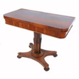 A 19th century rosewood card table, raised on a turned column terminating in a platform base,