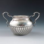 An American Sterling silver two handled sugar bowl, with half reeded body, engraved with initials