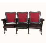 Three theatre or cinema seats, with hinged seats, having wooden framed backs, black upholstered seat