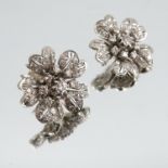 A pair of diamond flower head cluster ear studs, in unmarked white metal, the central diamond