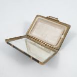 A lady's novelty compact, formed as a suitcase in faux tortoiseshell and gilt metal mounts, the