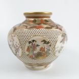 An Oriental pierced Satsuma vase, of bulbous form, decorated with alternate roundels of figures