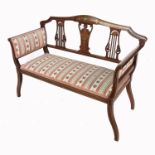 An Edwardian settee, having line and floral decoration raised on slender legs, width 43ins