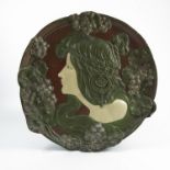 An Ernst Wahliss Turn-Wien Art Nouveau pottery wall plaque, of shaped circular form, decorated