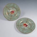 A pair of Royal Worcester cabinet plates, the centres decorated with fruit to a mossy background