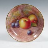 A Royal Worcester circular dish, decorated with fruit to a mossy background by Maybury, diameter 4.