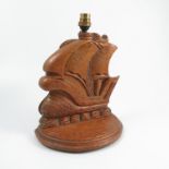A carved oak lamp base, formed as a galleon ship in full sale, on a semi circular base, height
