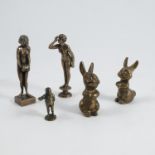 Two metal models, of female nudes, height 4ins, together with a small metal Dickensian figure,