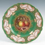 A Royal Worcester plate, decorated with a central fruit panel of two apples, blackberries and flower