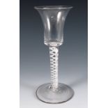 An 18th century English drinking glass, with flared bowl, the stem with double opaque twist,