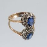 A 9ct gold cluster ring, set with a sapphire surrounded by diamonds