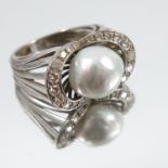 A grey cultured pearl and diamond ring, the white mount stamped '18k', the pearl of approximately