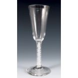 An 18th century English drinking glass, with conical bowl, the stem with double opaque twist, raised