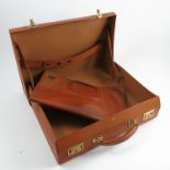 A Dunhill London tan leather suitcase, the interior of the lid with straps containing a leather