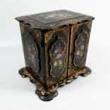 A 19th century black papier mache two door cabinet, decorated in gilt and inlaid mother of pearl