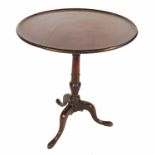 A 19th century mahogany tilt top tripod table, raised on a turned column terminating in three