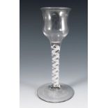An 18th century English drinking glass, with flared baluster bowl, the stem with double opaque