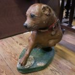 A painted composition model, of a seated dog with bent paw and the other paw on a tortoise, height