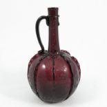 A 19th century amethyst glass decanter, the bulbous body etched with figures, birds and a vine,