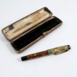 A cased Parker lacquered fountain pen, in mottled green and brown