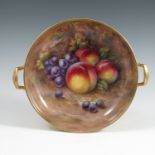 An English porcelain circular bowl, the interior painted with fruit to a mossy background by R Budd,