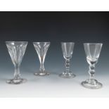 A pair of Antique cordial glasses, with knopped stems and raised on a folded foot, height 5ins,