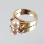 A cultured pearl ring, stamped '18ct', the 7mm diameter pearl with a small brilliant cut diamond