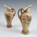 A pair of Royal Worcester blush ivory ewers, decorated with thistles and flowers, shape number 1587,