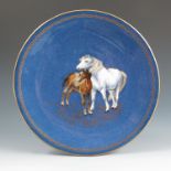 A Wedgwood plate, decorated with a Sabrina style blue ground Welsh pony and bay foal, with gilt