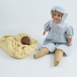 A bisque shoulder head doll, impressed A.M Beauty 2 1/2, Made in Germany, with sleeping eyes, fabric